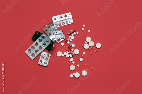 Scattered pills and used empty blisters