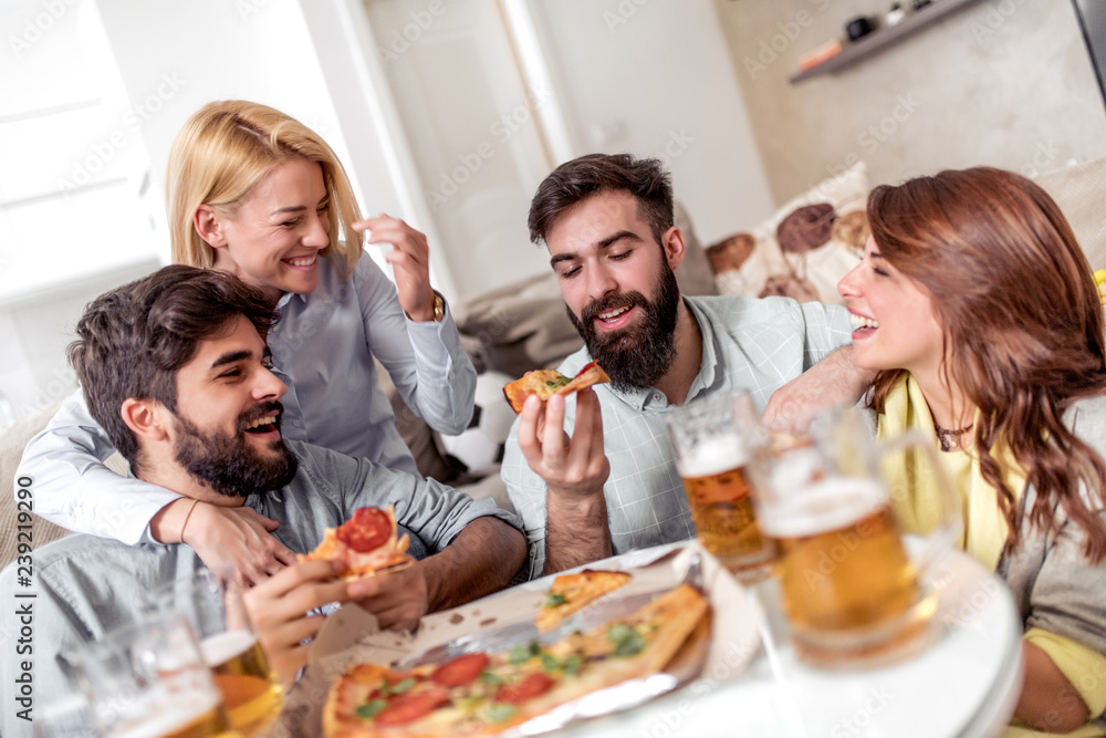 Group of friends enjoying pizza and beer Group of friends enjoying pizza and beer