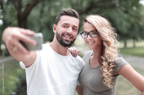 close up.smiling young couple taking selfie in city Park © ASDF