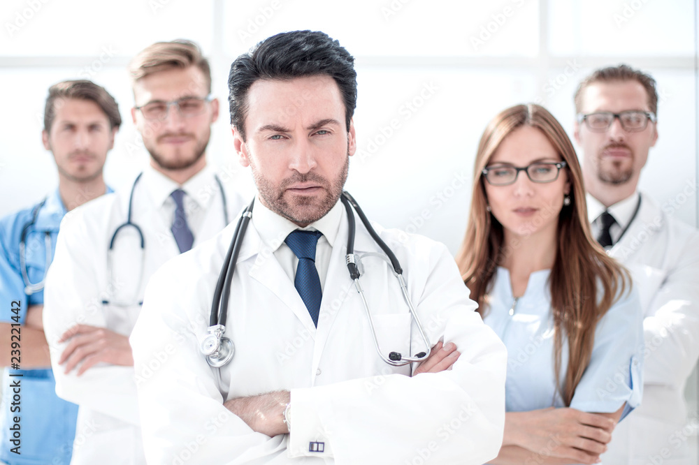 confident doctor on the background of colleagues confident doctor on the background of colleagues