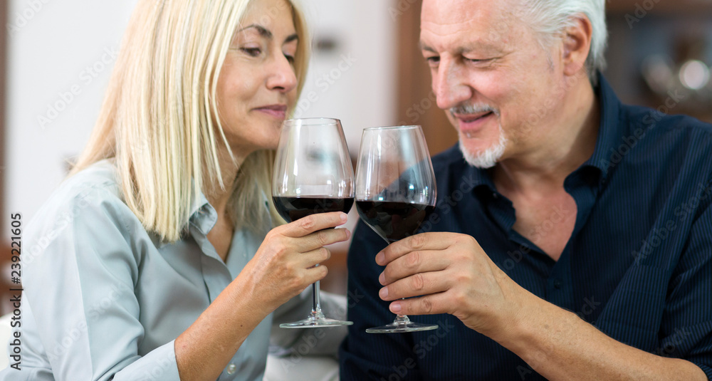 Portrait of a mature couple drinking a glass of red wine Portrait of a mature couple drinking a glass of red wine