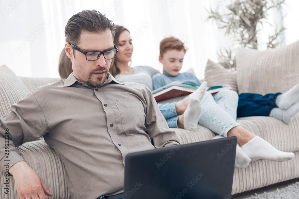 young man using laptop in his house young man using laptop in his house