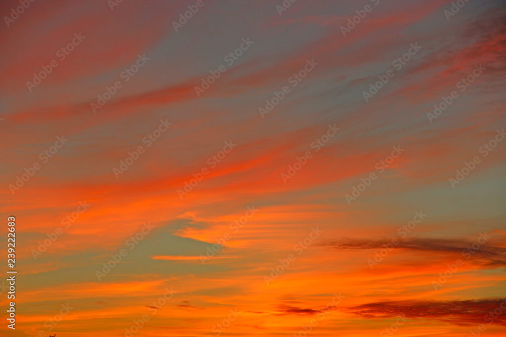 Orange sunset before night. Twilight with bright sunset. Evening landscape