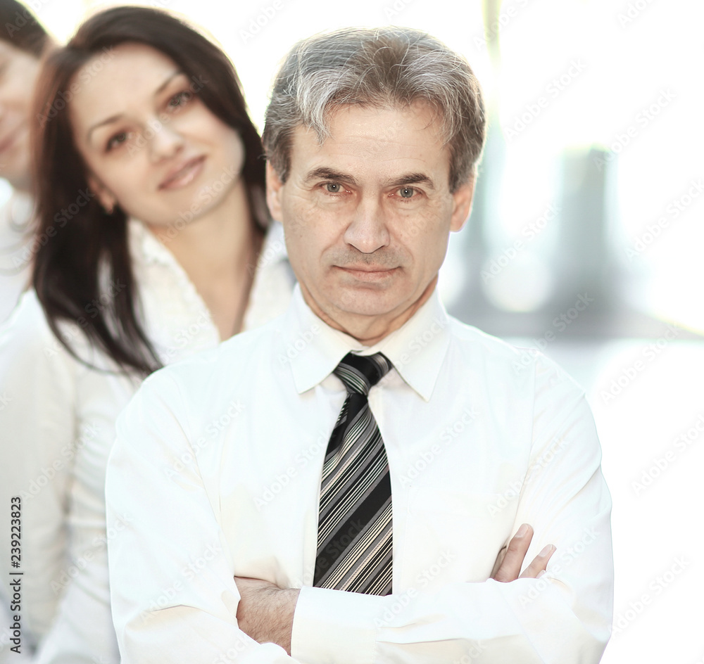 leader and the business team standing behind him. leader and the business team standing behind him.