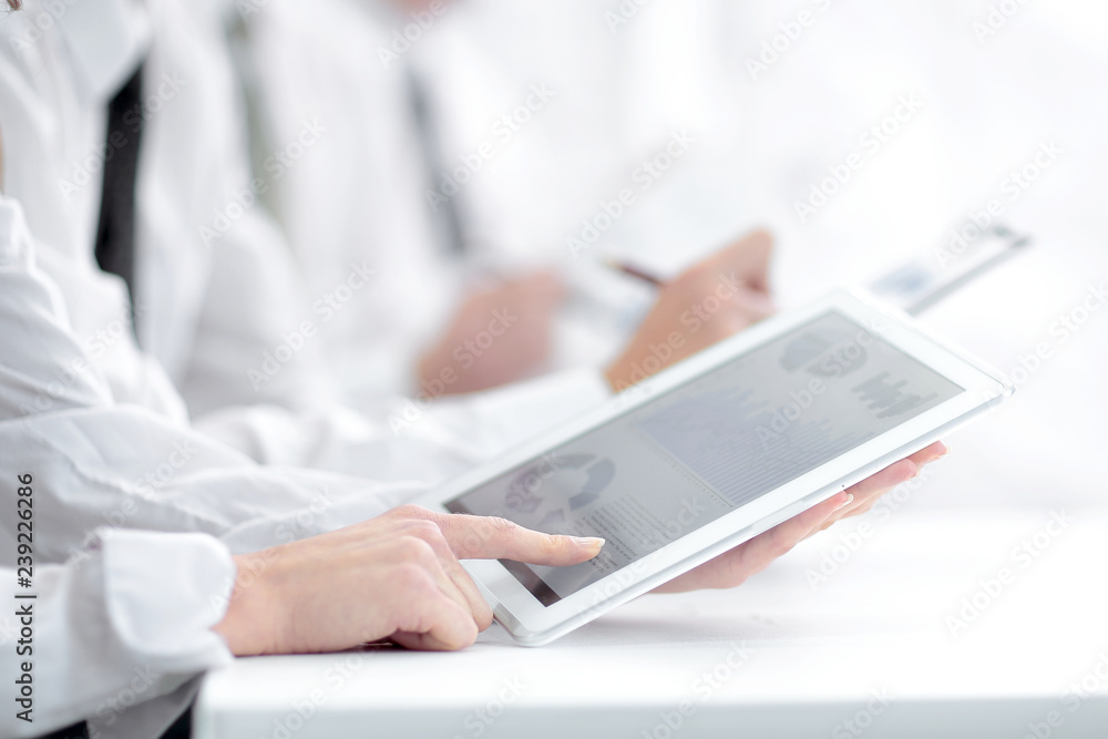 Fototapeta premium close up.an employee uses a digital tablet at a work meeting