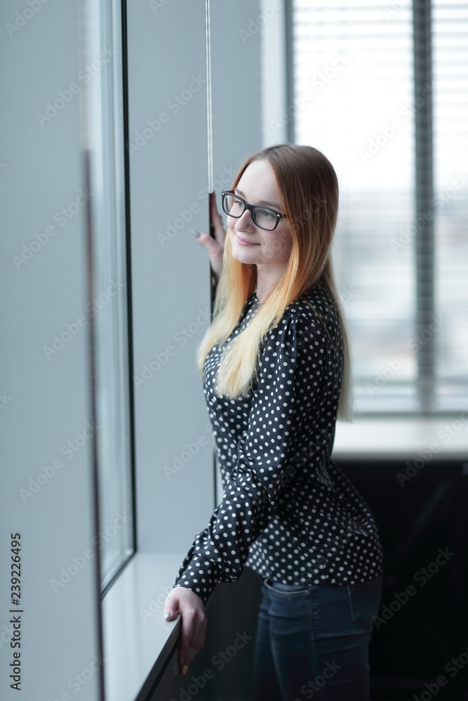 business woman standing near window in office