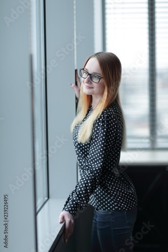 business woman standing near window in office