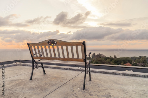 rooftop bench with sea and sunset view