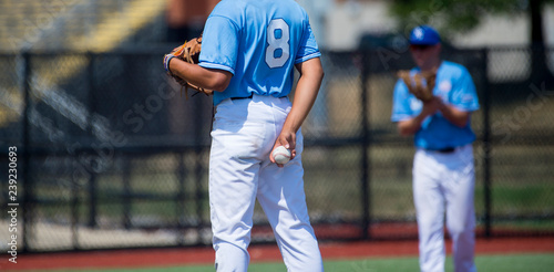 Photography Closeup from the back of baseball player in blue jersey
