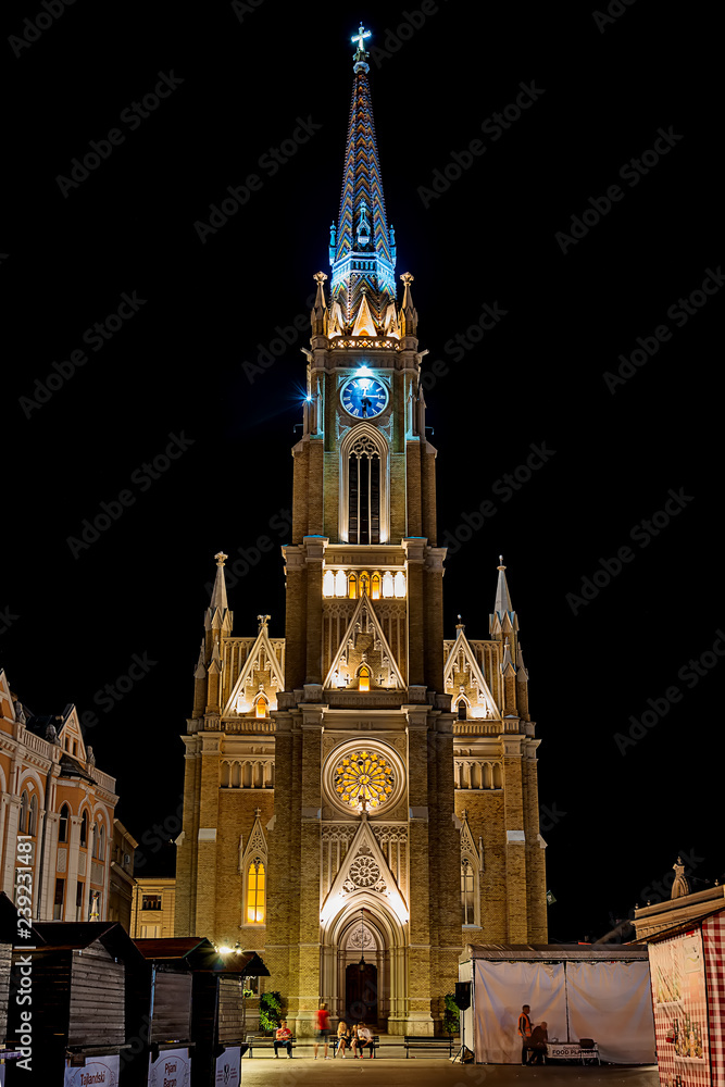 Novi Sad, Serbia May 27, 2018 : Night view of the Liberty Square (Trg. Slobode) with Mary Church, tourists and old buildings.