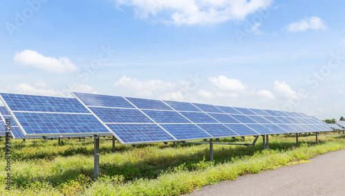 rows array of polycrystalline silicon solar cells or photovoltaic cells in solar power plant station turn up skyward absorb the sunlight from the sun  photo