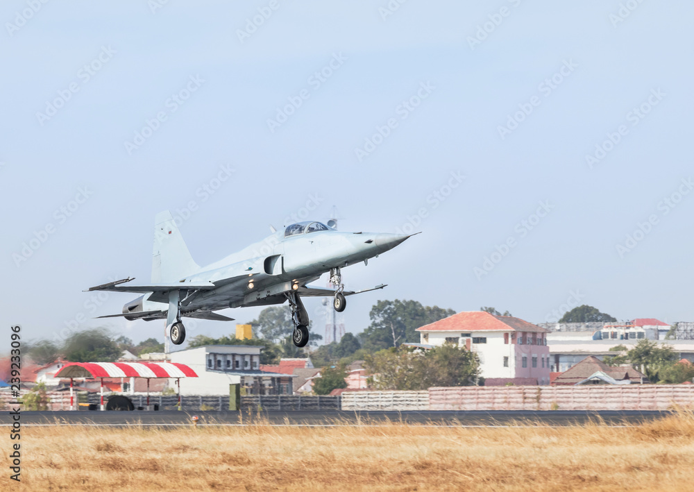 Fototapeta premium Fighter jet military aircraft flying with high speed take off from runway with steam from exhaust
