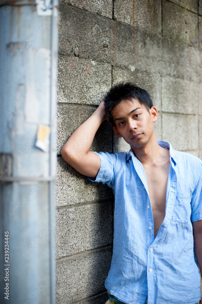Obraz premium Asian male model poses for pictures on the street