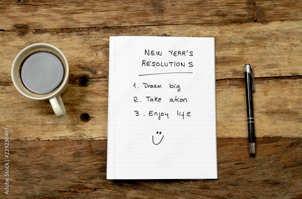 Plakat 2019 New Year Resolutions written on notebook and coffee on wood table in Goals for happy life