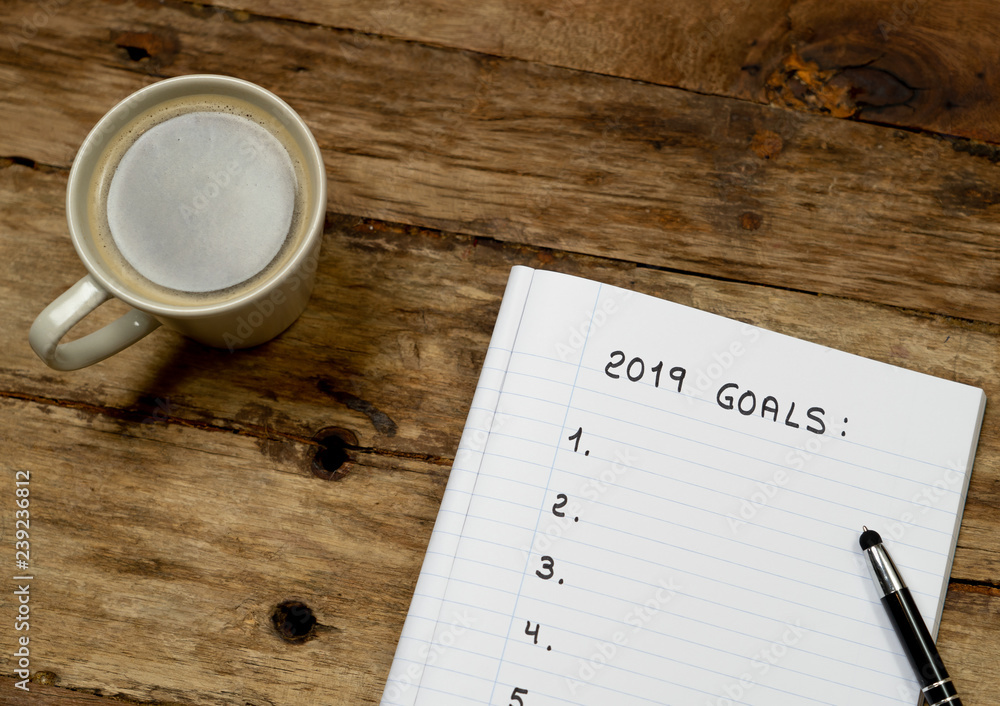 Plakat 2019 Goal list copy space on notepad and coffee on wood table in New Years resolution for happy life