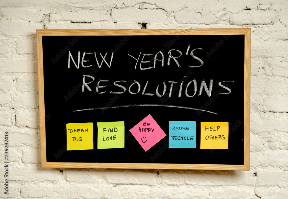 Fototapeta premium New Year resolutions or popular Goals and colorful sticky post its notes on chalk blackboard