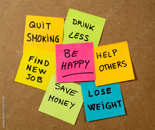 New Year resolutions or popular Goals and colorful sticky post its memo notes on cork board
