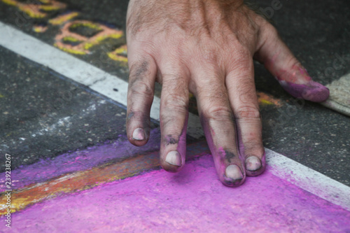 Hand painting abstract chalk art on the streets of San Diego California