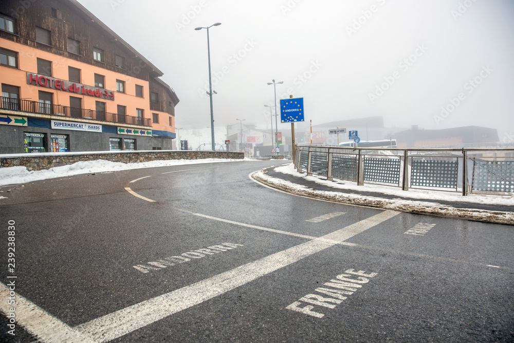 Andorra, Europe - Dec 2nd 2017 - The line which separate the border of France and Andorra in Europe in a cloud snowy day in Europe