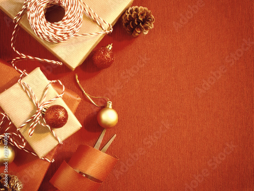 Preparing for the holiday - wrapping Christmas or Christmas gifts in red and beige wrapping paper