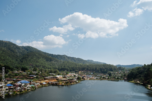 home town in the River with blue cloudy sky, Riverside view at Rak Thai Village, Mae hong son, Thailand © Pantira