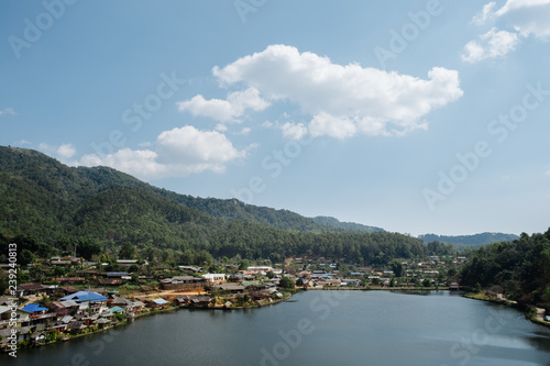 home town in the River with blue cloudy sky, Riverside view at Rak Thai Village, Mae hong son, Thailand