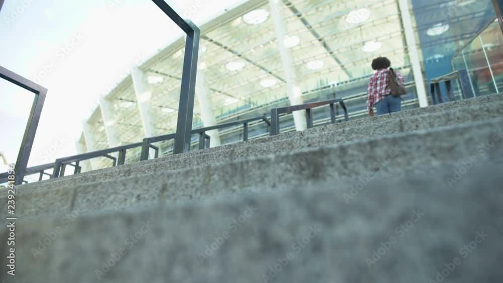 custom made wallpaper toronto digitalYoung afro-american woman running-up sports club stairs, bottom view on girl