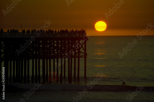 Crowd watching the sun setting over the Crystal Pier in Pacific Beach  San Diego  California