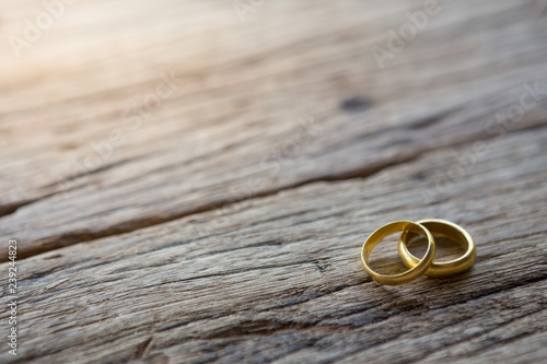 Two gold rings on wooden photo