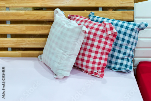 Modern white, red, blue checkered pattern fabric pillow on luxury fabric sofa interior