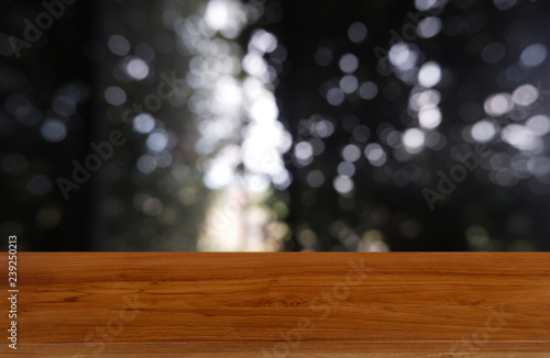 Empty wooden table in front of abstract blurred green of garden and house background. For montage product display or design key visual layout - Image.