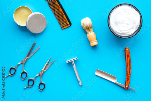 barbershop desk with tools for male care blue background top view