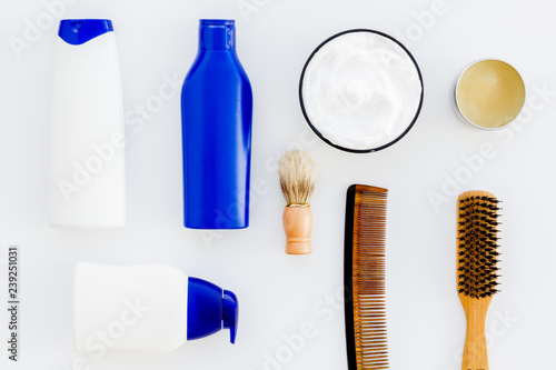 Instruments of male hairdresser with shampoo and comb in barbershop top view on white background mock up