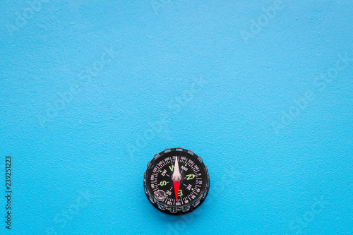 Direction of movement. Compass on blue background top view copy space