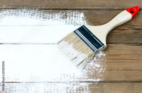 Paint brush on a painted wooden surface, background, copy space