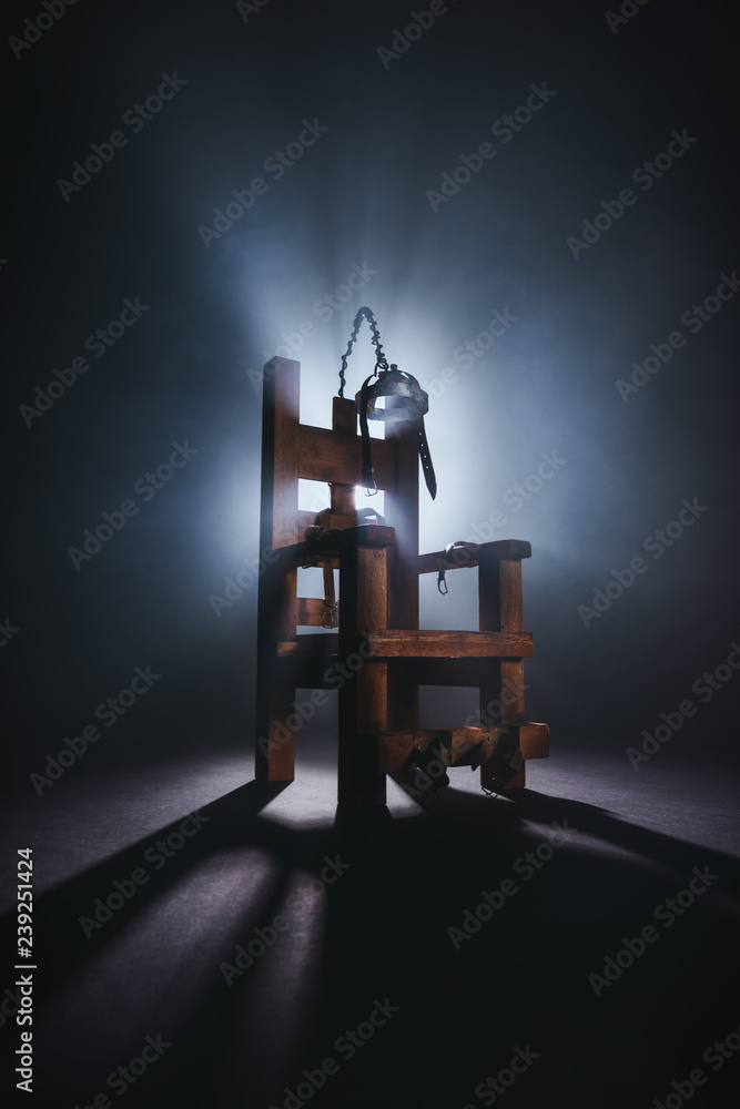 Electric chair in a dark background Stock Photo | Adobe Stock