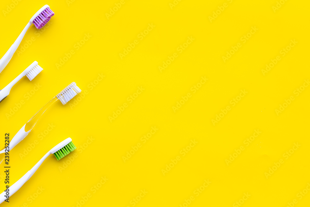 Tooth care with toothbrush. Set of cleaning products for teeth on yellow background top view copy space Tooth care with toothbrush. Set of cleaning products for teeth on yellow background top view copy space