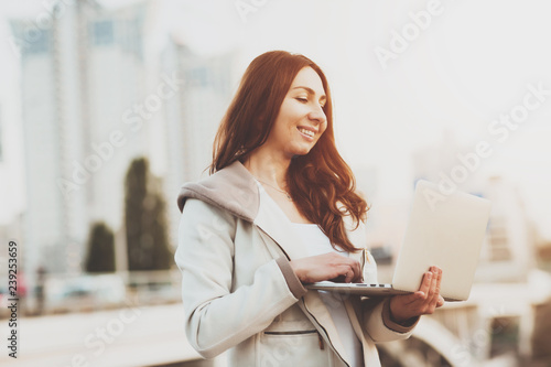 A young girl looks at information on a laptop