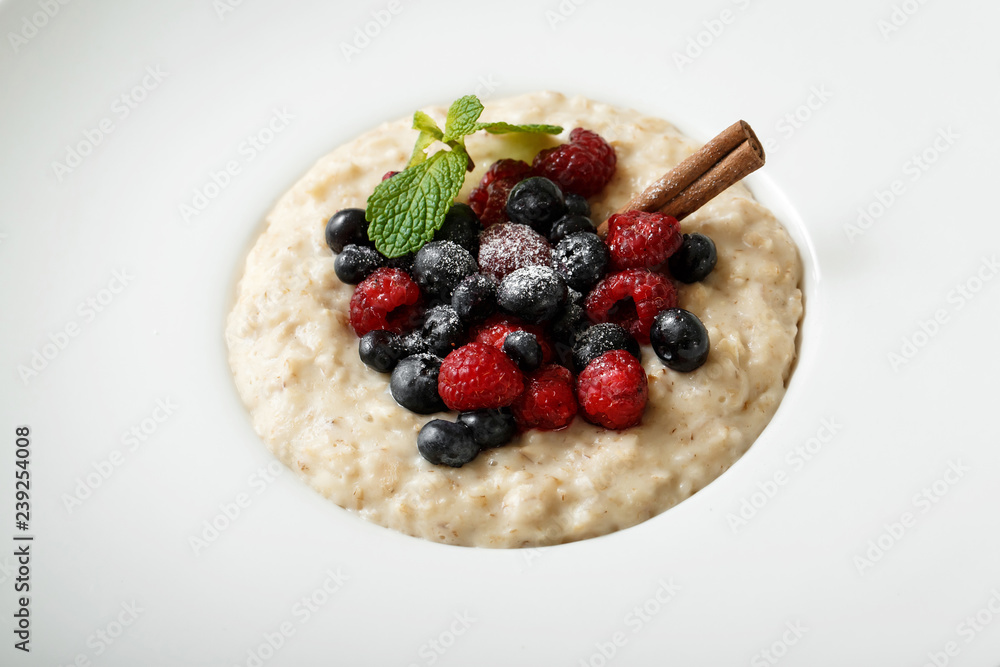 Close up of oatmeal with berries on white plate Close up of oatmeal with berries on white plate