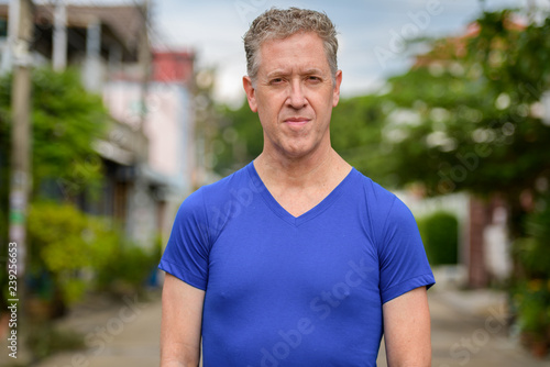Mature man looking at camera in the streets outdoors