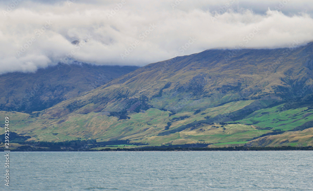Cloud covered mountains reaching into the sea Cloud covered mountains reaching into the sea