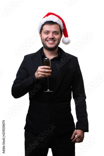 Photo of happy man in santa hat with glass of champagne in his hands © snedorez