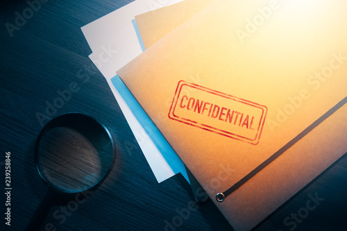 private detective desk with envelopes labeled as confidential photo