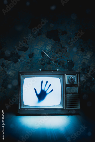 Retro television with white noise and a hand inside/ high contrast image