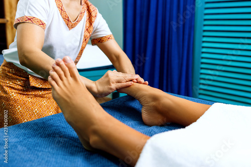 Woman having feet massage in spa salon.