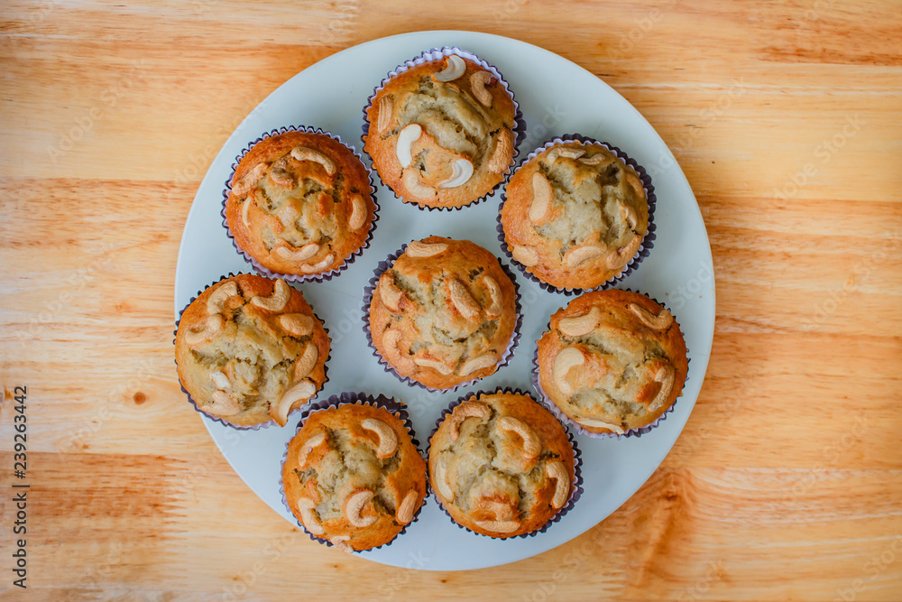 Homemade banana cupcake with wood background. Homemade banana cupcake with wood background.