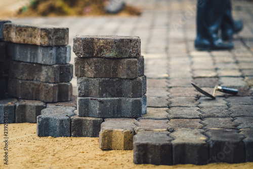 School janitor builds a brick pathway in school