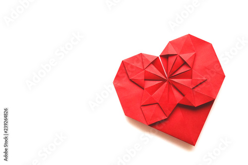 Isolated red paper heart made in origami technique on a white background. Concept of love, celebration, care, health, life