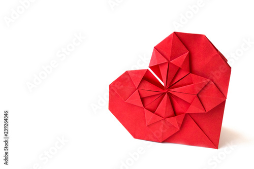 Isolated red paper heart made in origami technique on a white background. Concept of love  celebration  care  health  life