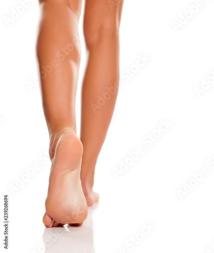 Beautiful woman legs and feet on white background photo